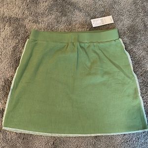 Soft green skirt w/ white side stitching. Elastic band. Never worn